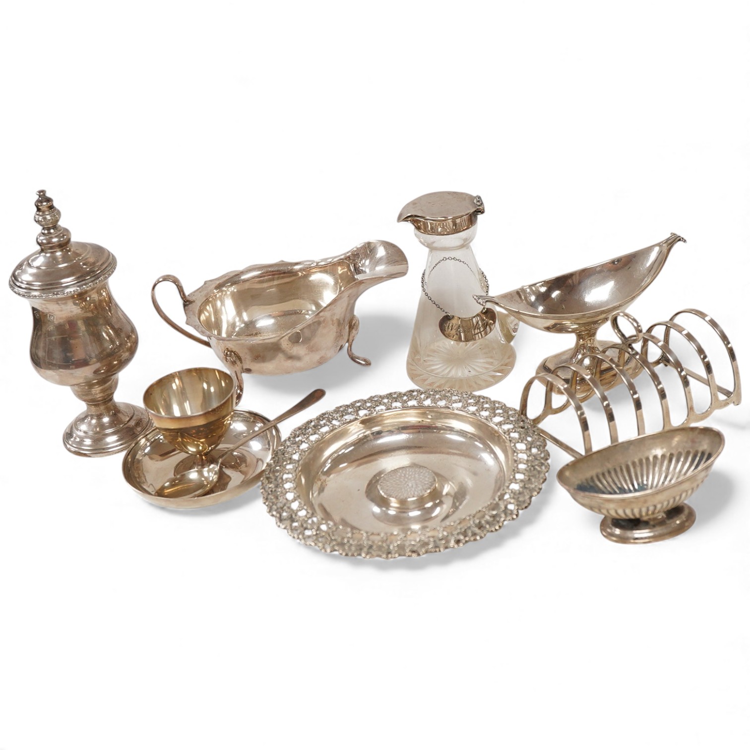 A group of assorted small silver including an Elizabeth II small circular dish by Stuart Devlin, London, 1985, diameter 13.5cm, a sauceboat, a 1920's seven bar toastrack, two pedestal salts including late Victorian, an e
